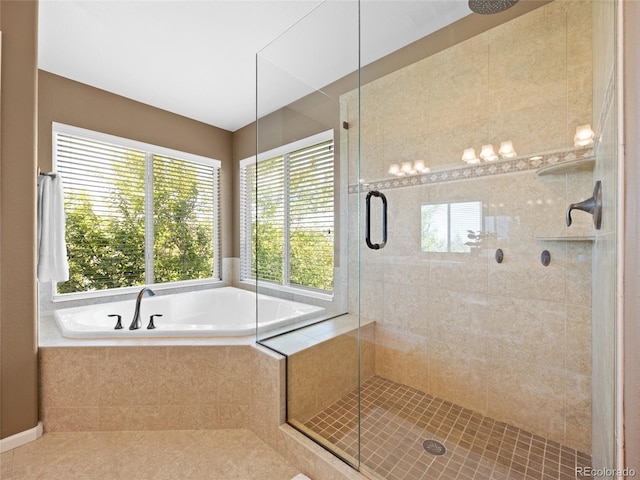 bathroom featuring a shower stall, a bath, and tile patterned floors