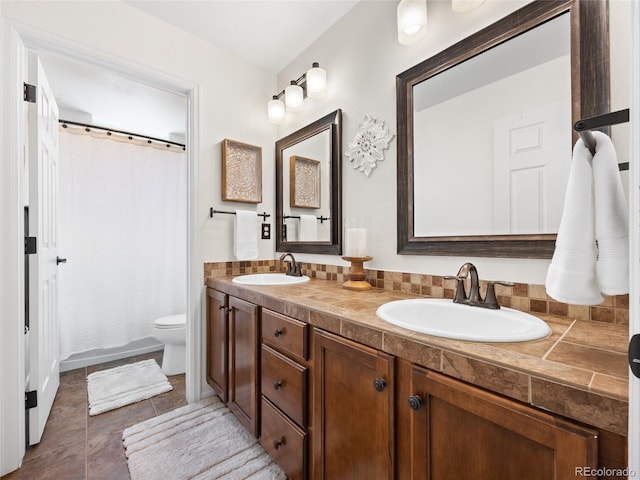 bathroom with double vanity, toilet, a shower with shower curtain, and tile patterned flooring