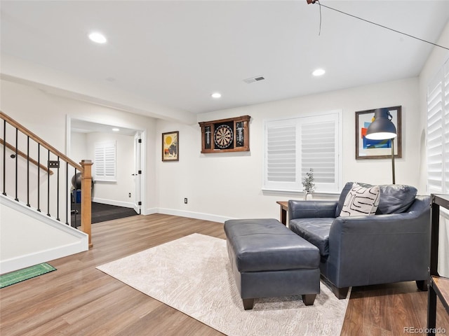 living area with stairway, wood finished floors, recessed lighting, and baseboards