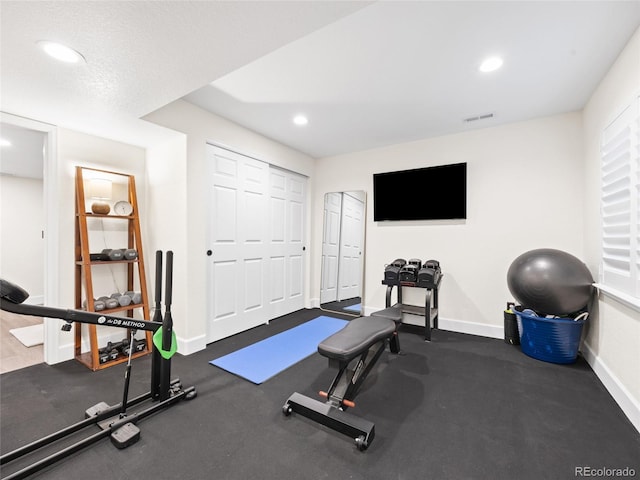 workout room with baseboards and recessed lighting