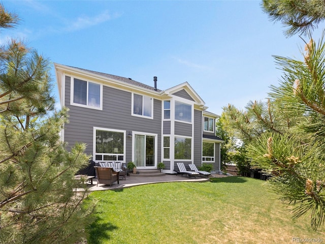 back of property with a patio and a lawn