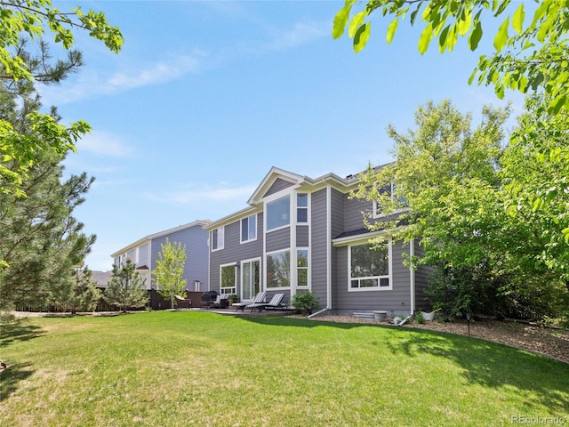 back of property with a lawn