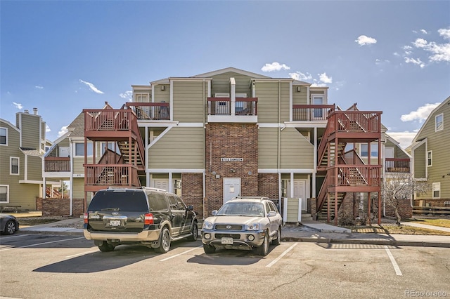 view of front of house with stairs and uncovered parking