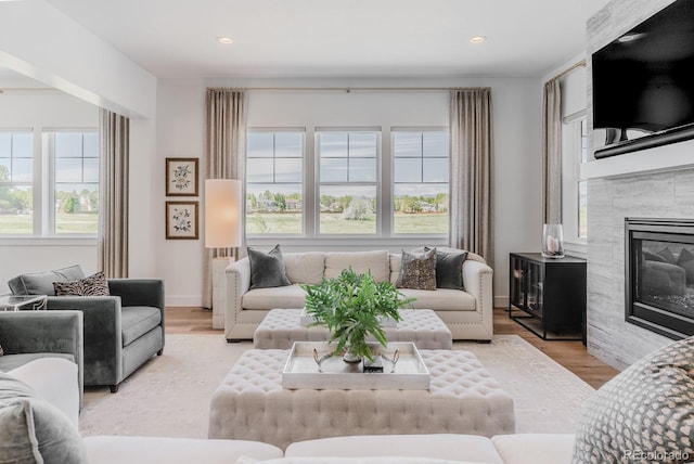 2141 Fountain Cir, Erie, CO 80516 - living room featuring recessed lighting, a glass covered fireplace, and wood finished floors