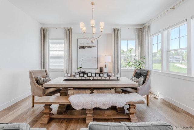 2141 Fountain Cir, Erie, CO 80516 - dining space with a chandelier, light wood finished floors, and baseboards
