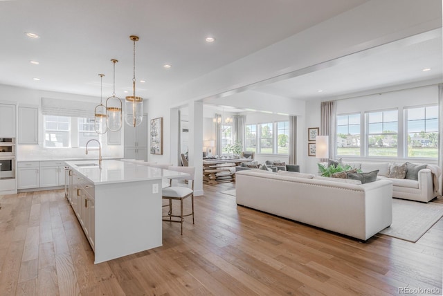 2141 Fountain Cir, Erie, CO 80516 - kitchen with open floor plan, a sink, a chandelier, healthy amount of natural light, and recessed lighting