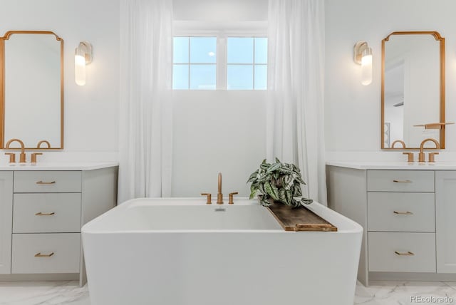 2141 Fountain Cir, Erie, CO 80516 - full bathroom featuring marble finish floors, a freestanding tub, and two vanities