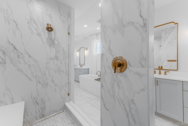 2141 Fountain Cir, Erie, CO 80516 - bathroom featuring a freestanding bath, two vanities, a marble finish shower, marble finish flooring, and recessed lighting