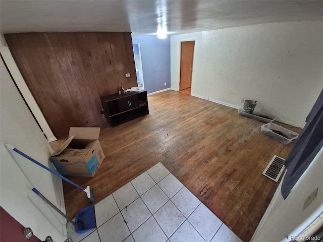 1078 Elmira St, Aurora, CO 80010 - unfurnished living room featuring wood walls and tile patterned flooring