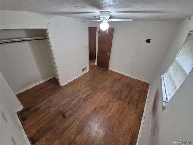 1078 Elmira St, Aurora, CO 80010 - unfurnished bedroom with wood finished floors, a textured ceiling, a closet, and baseboards
