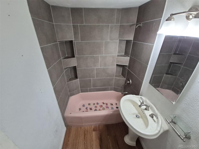 1078 Elmira St, Aurora, CO 80010 - full bathroom featuring wood finished floors and tiled shower