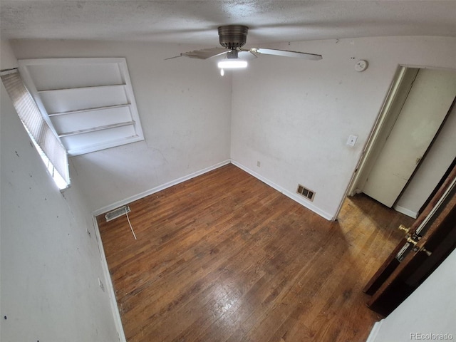 1078 Elmira St, Aurora, CO 80010 - empty room with wood finished floors, ceiling fan, baseboards, a textured ceiling, and a smoke detector