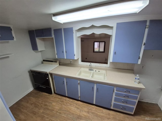 1078 Elmira St, Aurora, CO 80010 - kitchen featuring blue cabinetry, a sink, stove, and light countertops