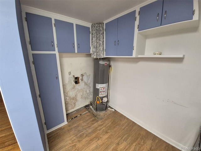 1078 Elmira St, Aurora, CO 80010 - laundry area featuring gas water heater, dark wood-type flooring, and baseboards