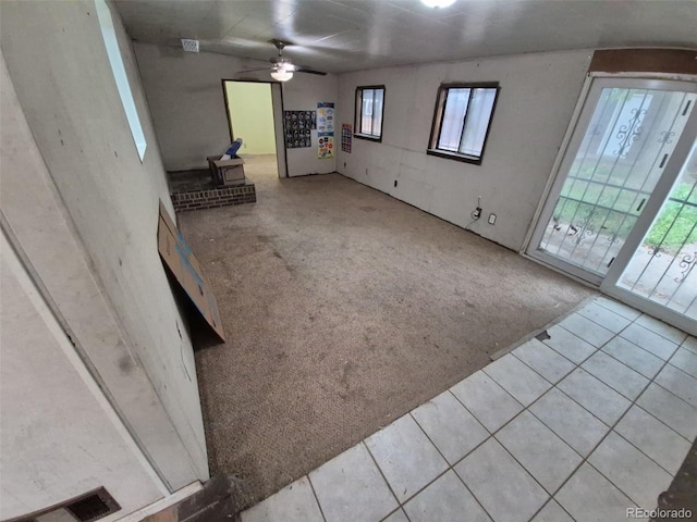 1078 Elmira St, Aurora, CO 80010 - unfurnished living room with carpet floors, a ceiling fan, and tile patterned flooring