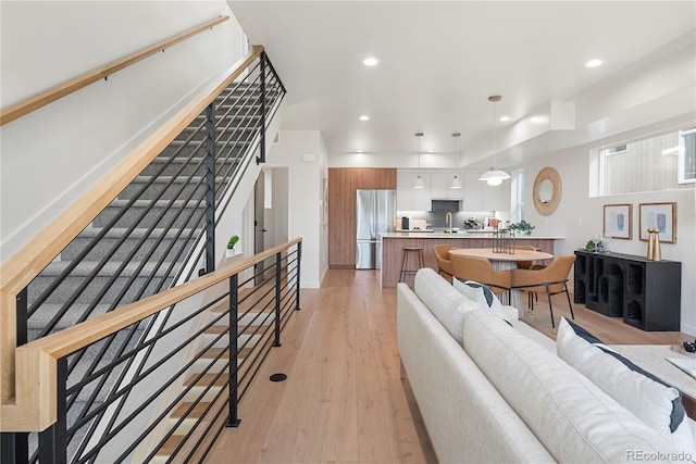 living room featuring light hardwood / wood-style floors and sink