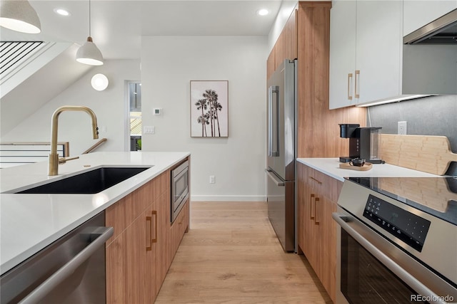 kitchen featuring sink, white cabinetry, stainless steel appliances, decorative light fixtures, and exhaust hood