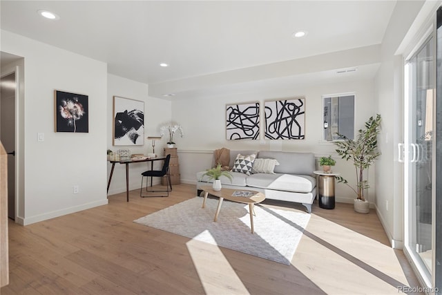 living area with recessed lighting, baseboards, and light wood-style floors