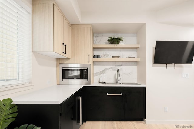 1262 N Stuart St Unit 2, Denver, CO 80204 - bar featuring stainless steel microwave, a sink, tasteful backsplash, baseboards, and light wood-type flooring