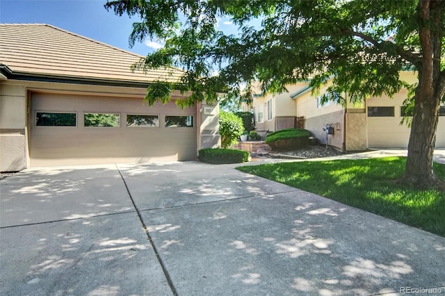 3325 W 111th Loop Unit C, Westminster, CO 80031 - view of front of property featuring concrete driveway, a tile roof, and stucco siding