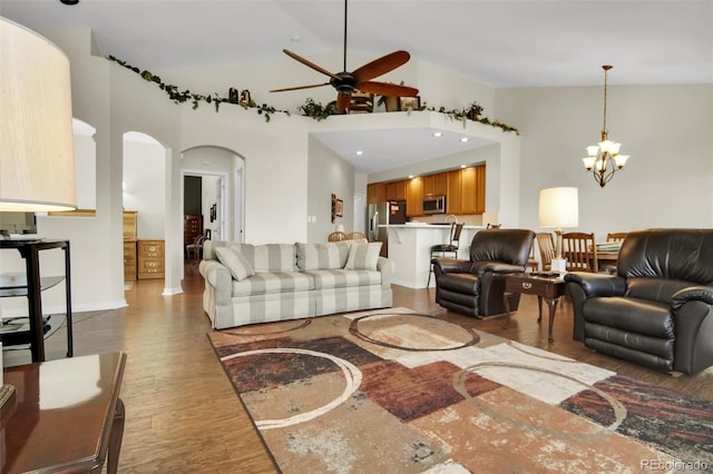 3325 W 111th Loop Unit C, Westminster, CO 80031 - living room with arched walkways, a chandelier, ceiling fan, high vaulted ceiling, and wood finished floors