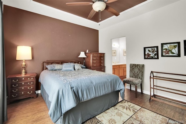 3325 W 111th Loop Unit C, Westminster, CO 80031 - bedroom with light wood-style flooring, a tray ceiling, ensuite bathroom, and ceiling fan