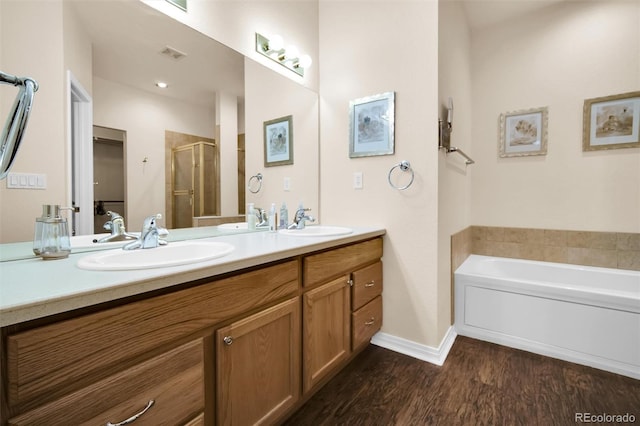 3325 W 111th Loop Unit C, Westminster, CO 80031 - full bathroom featuring a stall shower, double vanity, wood finished floors, and a garden tub