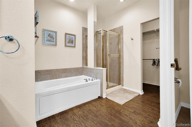 3325 W 111th Loop Unit C, Westminster, CO 80031 - bathroom with a walk in closet, a stall shower, a garden tub, wood finished floors, and recessed lighting