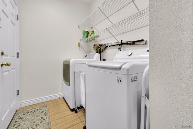 3325 W 111th Loop Unit C, Westminster, CO 80031 - washroom with independent washer and dryer and light wood-style flooring