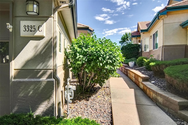 3325 W 111th Loop Unit C, Westminster, CO 80031 - view of side of home with stucco siding and a tile roof
