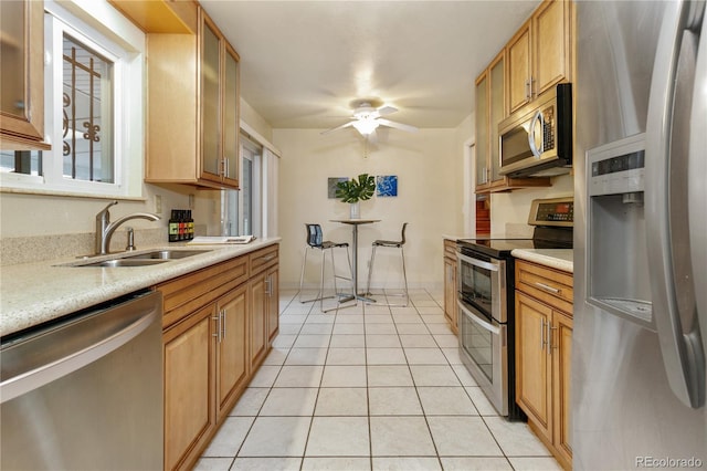 kitchen with ceiling fan, sink, light tile patterned floors, and appliances with stainless steel finishes