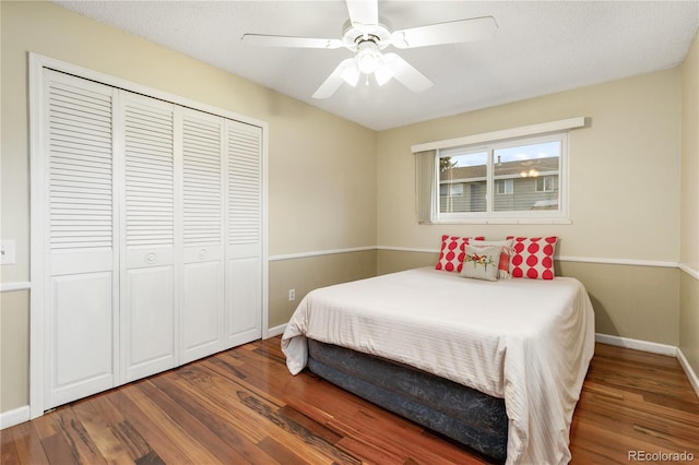 bedroom featuring a textured ceiling, a closet, dark hardwood / wood-style floors, and ceiling fan