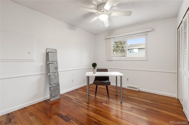 office area with hardwood / wood-style flooring, ceiling fan, and a textured ceiling