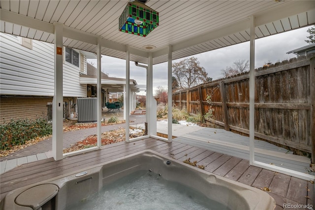 unfurnished sunroom with a hot tub and wood ceiling