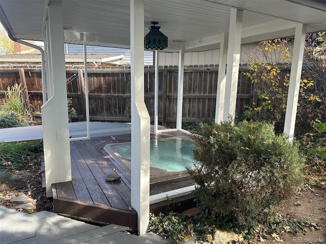 wooden deck with an outdoor hot tub