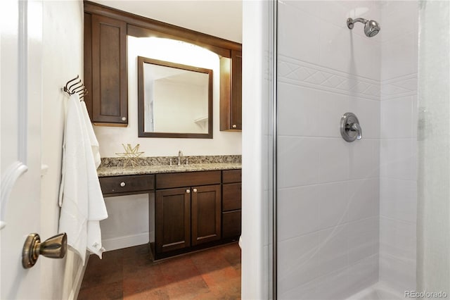 bathroom with vanity and tiled shower