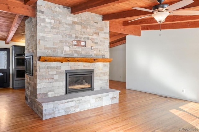 unfurnished living room with light wood-type flooring, wood ceiling, and a fireplace