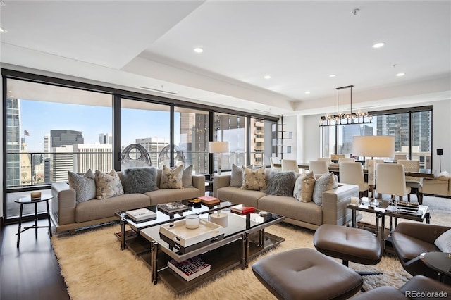 living room with a notable chandelier and light hardwood / wood-style flooring