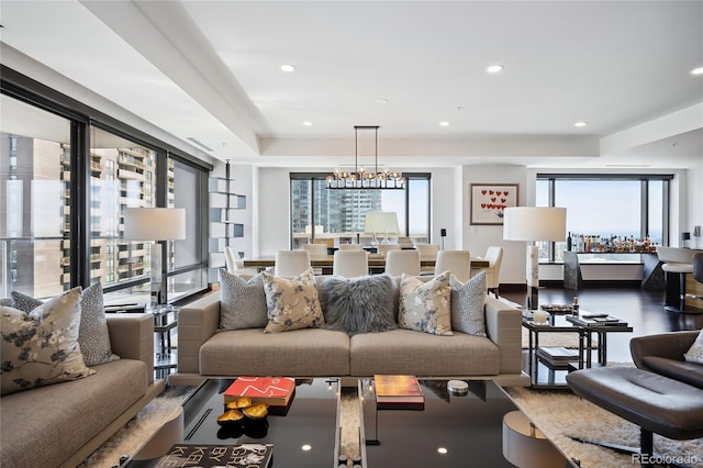 living room with an inviting chandelier and plenty of natural light