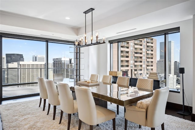 dining room with wood-type flooring, a chandelier, and a healthy amount of sunlight