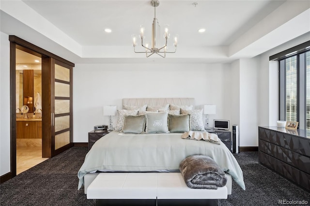 carpeted bedroom featuring an inviting chandelier and ensuite bath