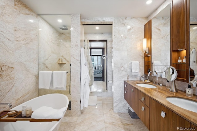 bathroom with tile walls, vanity, and a washtub