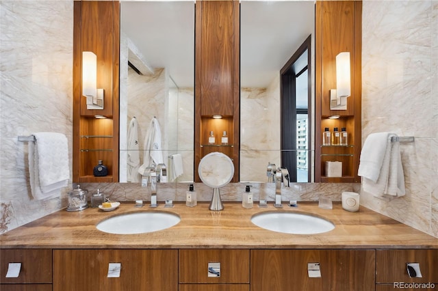 bathroom with tile walls, vanity, and tasteful backsplash