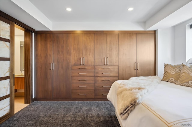 carpeted bedroom featuring ensuite bathroom