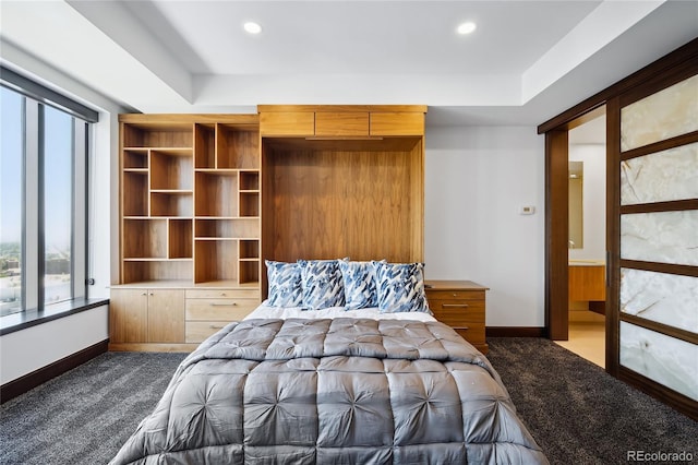 bedroom with dark colored carpet