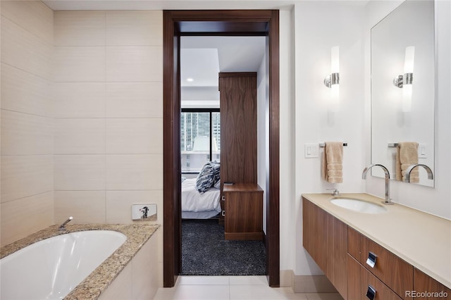 bathroom featuring vanity, tile patterned floors, and a relaxing tiled tub