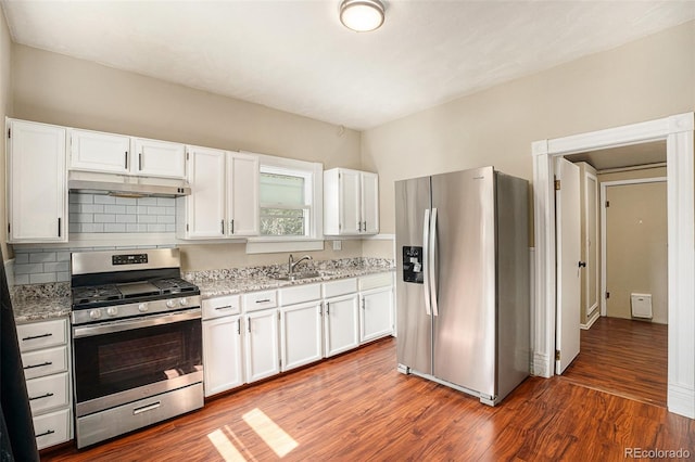 529 S Prospect St, Colorado Springs, CO 80903 - kitchen with stainless steel appliances, under cabinet range hood, white cabinetry, and light stone countertops