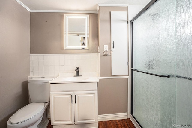 529 S Prospect St, Colorado Springs, CO 80903 - bathroom featuring vanity, a shower stall, crown molding, wood finished floors, and tile walls
