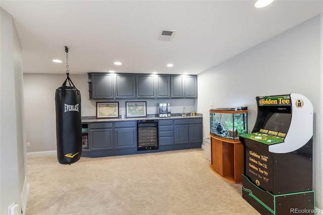 indoor wet bar featuring beverage cooler, light colored carpet, baseboards, and recessed lighting
