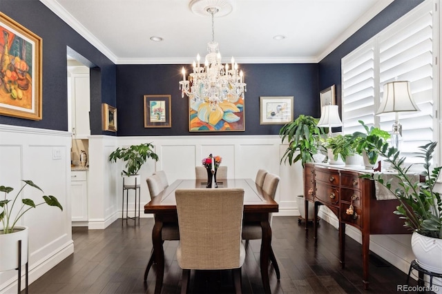 dining area featuring a chandelier, dark hardwood / wood-style flooring, and crown molding